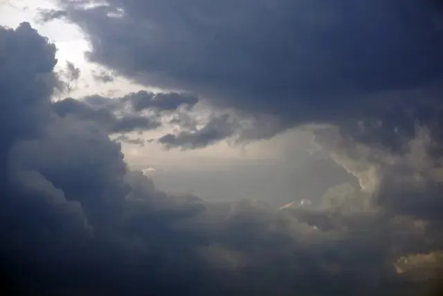 A storm front building over rooftops
